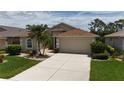 Charming single-story home features a well-manicured lawn, and a two car garage at 1566 Scarlett Ave, North Port, FL 34289