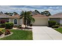 Charming single-story home features a well-manicured lawn, and a two car garage at 1566 Scarlett Ave, North Port, FL 34289
