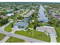 Aerial view of the property showing location on canal with boat docks and lush landscaping at 18652 Ohara Dr, Port Charlotte, FL 33948