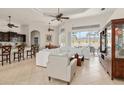 Bright living room featuring high ceilings, tile floors, and access to lanai at 18652 Ohara Dr, Port Charlotte, FL 33948