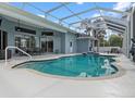 Inviting screened-in pool area with covered seating, ideal for relaxation and outdoor entertaining at 18652 Ohara Dr, Port Charlotte, FL 33948