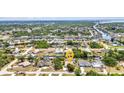 Wide aerial view showcasing the canal-front property with lush surroundings in a peaceful neighborhood at 18753 Klingler Cir, Port Charlotte, FL 33948