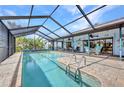 Inviting screened-in pool area perfect for relaxation, complete with a covered patio and comfortable seating at 18753 Klingler Cir, Port Charlotte, FL 33948