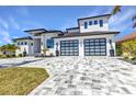 Beautiful home featuring a desert landscaped lawn, paved driveway, an attached two car garage, and a covered porch at 19 Sabal Dr, Punta Gorda, FL 33950