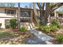 Condo exterior with screened in patio and mature landscaping at 19505 Quesada Ave # A204, Port Charlotte, FL 33948