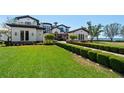 An expansive green lawn runs alongside the brick drive leading up to the beautiful residence at 2107 4Th Street W Ct, Palmetto, FL 34221
