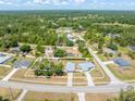 Aerial view of a home showcasing its layout, surrounding trees, and neighborhood streets at 2411 Atwater Dr, North Port, FL 34288