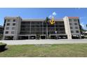 Multi-story condo building featuring balconies, covered parking, and well-maintained landscaping in a coastal setting at 25188 Marion Ave # F304, Punta Gorda, FL 33950