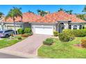 Stunning exterior view of a single-Gathering home with tile roof, well-manicured lawn, and brick-paved driveway at 303 11Th E Ave, Palmetto, FL 34221