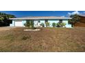 Inviting single-Gathering home with a blue exterior, landscaping, and a well-maintained front lawn at 4097 Rose Arbor Cir, Port Charlotte, FL 33948