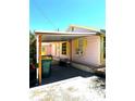 Charming home exterior featuring a covered patio and yellow trim, adding to its curb appeal at 4344 Commercial St, Port Charlotte, FL 33953