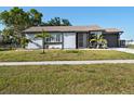 Charming single-story home with well-maintained lawn and tidy landscaping, creating great curb appeal at 5520 Kenwood Dr, North Port, FL 34287