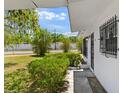 Inviting covered entry with decorative ironwork and vibrant landscaping details at 815 Papaya Dr, Tampa, FL 33619