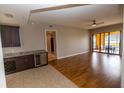 Spacious living room with hardwood floors, a wet bar, and sliding glass doors to the outdoor patio at 99 Vivante Blvd # 311, Punta Gorda, FL 33950