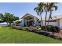 Inviting one-story home with lush landscaping and a well-manicured lawn at 12439 Prather Ave, Port Charlotte, FL 33981