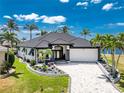 Stunning waterfront home with lush landscaping, decorative driveway, and luxurious curb appeal, perfect for upscale living at 1255 Eider Ct, Punta Gorda, FL 33950