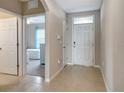 Inviting foyer with tile flooring and a view into a bedroom and the front door at 16031 Quinta Dr, Punta Gorda, FL 33955