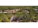 Expansive aerial view of a charming home surrounded by lush greenery and a serene waterway at 17356 Gulfspray Cir, Port Charlotte, FL 33948