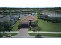 Beautiful single-Gathering home with well-manicured lawn and tropical landscaping and paver driveway at 1745 Hyssop Loop, North Port, FL 34289