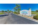 Community sign for Newport Condominiums and St. James Place with manicured landscaping and clear blue skies at 175 Kings Hwy # 1114, Punta Gorda, FL 33983