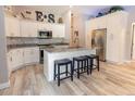 Bright modern kitchen with stainless steel appliances, island with seating, and white cabinetry at 21080 Firwood Ter, Port Charlotte, FL 33954