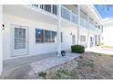 Close-up view of a condo exterior with clean white facade and neatly arranged landscaping at 22375 Edgewater Dr # 128, Port Charlotte, FL 33980