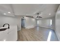 Bright living room with laminate floors, ceiling fan and recessed lighting for a modern feel at 23344 Van Buren Ave, Punta Gorda, FL 33980