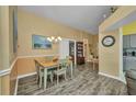 Dining room with hardwood floors, chandelier, and large painting, perfect for Gathering meals at 24317 Kintail Ct, Punta Gorda, FL 33980
