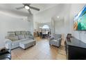 Bright living room with tile floors, a ceiling fan, and neutral decor, offering a welcoming space at 2751 S Cranberry Blvd, North Port, FL 34286