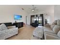Spacious living room featuring tile floors, neutral decor, and ample space for comfortable seating at 2751 S Cranberry Blvd, North Port, FL 34286