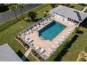 Inviting community pool with lounge chairs and a meticulously kept pool house at 3310 Loveland Blvd # 1503, Punta Gorda, FL 33980