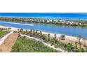 Scenic aerial view of a beach community with lush greenery and waterfront access at 3319 Shamrock Dr, Venice, FL 34293