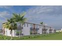 Townhome complex exterior showcasing back patios, second-story balconies, and lush green landscaping at 3609 Bal Harbor Blvd, Punta Gorda, FL 33950