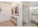 Bright entryway featuring neutral decor and access to a well-lit bathroom at 43050 Greenway Blvd # 645, Punta Gorda, FL 33982