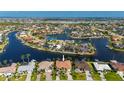 Aerial view of a waterfront community with homes, canals, and boat docks at 436 Monaco Dr, Punta Gorda, FL 33950