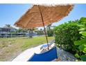 Relaxing backyard with beach umbrellas and waterfront views at 48 Hibiscus Dr, Punta Gorda, FL 33950