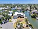 Gorgeous waterfront home with lush landscaping, a private backyard, and access to the canal, perfect for boating at 5181 Sandy Shore Ave, Sarasota, FL 34242
