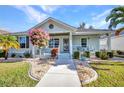 Inviting front porch featuring a decorative door, lush landscaping and a small seating area at 526 Allen St, Punta Gorda, FL 33950
