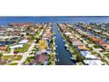 Scenic aerial view of a waterfront community with private docks, lush greenery, and easy access to the open water at 80 Hibiscus Dr, Punta Gorda, FL 33950