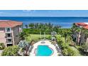 Serene aerial view shows a community pool, manicured gardens, and stunning waterfront location at 95 N Marion Ct # 135, Punta Gorda, FL 33950