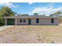 Charming single story home featuring an attached garage and well-maintained lawn at 105 Biscayne Dr, Port Charlotte, FL 33953