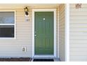 The front door is green and has a white frame, with the house number in the upper left at 105 Biscayne Dr, Port Charlotte, FL 33953