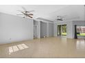 Open concept living room with tile floors and recessed lighting and access to the outdoor space at 1275 Huntington St, North Port, FL 34288