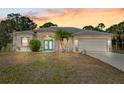 Lovely single-story home with a vibrant turquoise front door and well-maintained lawn at 1313 Wise Dr, North Port, FL 34286