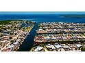 Aerial view of waterfront homes on canal with direct access to the open bay at 148 Peckham St Se, Port Charlotte, FL 33952