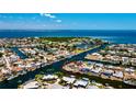 Aerial view of waterfront homes on canal with direct access to the open bay at 148 Peckham St Se, Port Charlotte, FL 33952