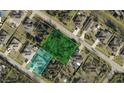 An aerial shot showing property lines of an overgrown lot with a street name at 1488 Squaw Ln, North Port, FL 34286