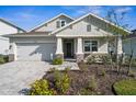 Inviting front exterior with stone accents, manicured landscaping, and a welcoming entrance at 16029 Mulrion Blvd, Punta Gorda, FL 33982