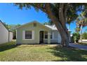 Lovely one-story home with mature trees and a lush green lawn at 19583 Kapok Ct, Port Charlotte, FL 33952