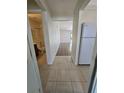 Hallway with tile and wood flooring leading to different rooms, including a bathroom at 19583 Kapok Ct, Port Charlotte, FL 33952
